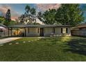 Beautiful single-story home featuring a pristine front lawn and covered carport at 210 Pinehurst Dr, Auburndale, FL 33823