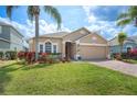 Charming single-Gathering home with a well-manicured lawn, beautiful landscaping, and a brick paver driveway at 225 Highgate Park Blvd, Davenport, FL 33897
