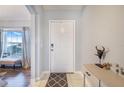 Bright entryway featuring a white front door, neutral walls, and stylish decor at 238 Lake Eloise Pointe Blvd, Winter Haven, FL 33880