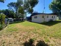 Green backyard featuring a partial fence that offers both privacy and a clear view of the surroundings at 2927 Walnut St, Winter Haven, FL 33881