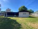 Rear exterior view showing a screened-in porch and the layout of the backyard, perfect for outdoor living at 2927 Walnut St, Winter Haven, FL 33881