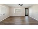 Bright living room featuring modern flooring and a view through the glass-paned back door at 319 Thomas Ave, Frostproof, FL 33843