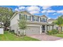 An appealing exterior showing a two-car garage, blue shutters, and lush landscaping at 3217 La Salle St, Winter Haven, FL 33884