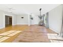 Inviting living space featuring hardwood floors, a modern chandelier, and neutral paint at 3736 Knights Station Rd, Lakeland, FL 33810