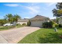 Attractive home featuring a spacious driveway and beautiful landscaping at 3905 Osprey Pointe Cir, Winter Haven, FL 33884