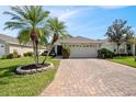 Charming single-story home with a brick driveway and lush landscaping at 3905 Osprey Pointe Cir, Winter Haven, FL 33884