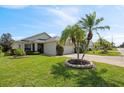 Well-manicured lawn and tropical landscaping enhance the curb appeal of this lovely home at 3905 Osprey Pointe Cir, Winter Haven, FL 33884
