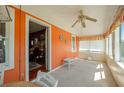 Bright sunroom with an orange wall, white wicker table, and access to the living room at 555 Morrel Ave, Lake Wales, FL 33859