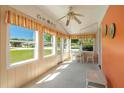 Bright sunroom featuring many windows, a ceiling fan, and a table for seating at 555 Morrel Ave, Lake Wales, FL 33859