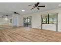Bright living room with modern flooring, ceiling fans, and sliding glass doors to the lanai at 602 Turnberry Ct, Winter Haven, FL 33884