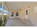 Covered patio with concrete flooring, offering an inviting outdoor space with access to the home at 6433 Jacaranda Ne Ave, Winter Haven, FL 33881