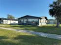 Charming single-story home featuring a well-manicured lawn and dark brick exterior at 707 Great Barford St, Auburndale, FL 33823