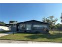 Charming single-story home featuring a well-manicured lawn, dark brick exterior, and a cozy, inviting curb appeal at 707 Great Barford St, Auburndale, FL 33823