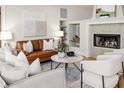 Bright living room features a fireplace, large sofa, and neutral decor for a modern aesthetic at 819 Seminole Rd, Babson Park, FL 33827