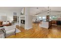Spacious open floor plan featuring fireplace, hardwood floors, kitchen and dining areas at 819 Seminole Rd, Babson Park, FL 33827