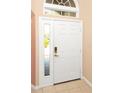 Bright front door featuring sidelight windows that offer plenty of sunlight at 908 Orista Dr, Davenport, FL 33897