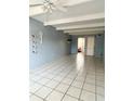 Open living room with tile flooring, ceiling fan, and exposed beam ceiling at 1219 Club Cir, Lakeshore, FL 33854