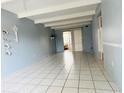 Bright living room with tile floors and sliding glass doors to the exterior at 1219 Club Cir, Lakeshore, FL 33854