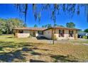 Charming single story home with stone accents, shuttered windows, and mature trees at 122 Wgto Tower Rd, Lake Alfred, FL 33850
