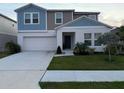 Charming two-story home with a well-maintained front yard and attached two-car garage at 1393 Axel Cir, Winter Haven, FL 33880