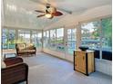 Bright sunroom with lots of natural light, a ceiling fan, and views of the waterfront property at 167 Bonnie Dr, Auburndale, FL 33823