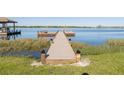 Wooden dock extending into the serene lake, perfect for fishing, boating, and enjoying waterfront outdoor activities at 169 Summershore Dr, Auburndale, FL 33823