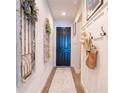 Stylish entryway with a decorative rug, black door, decorative mirrors and white wainscoting, creating a welcoming first impression at 169 Summershore Dr, Auburndale, FL 33823