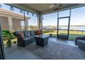 Relaxing screened patio offers comfortable seating and a beautiful view of the lake at 169 Summershore Dr, Auburndale, FL 33823