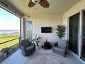 Comfortable screened porch with seating and view of the water at 169 Summershore Dr, Auburndale, FL 33823