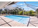 Screened-in pool featuring ample deck space for entertaining with a clear blue sky overhead at 2 Bridgewater Dr, Winter Haven, FL 33884