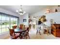 Cozy dining area with large window, seamlessly connecting to an open kitchen and living space at 217 Kent Ct, Haines City, FL 33844