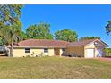 Spacious single-story home with a well-kept lawn, red-tiled roof and a two-car garage at 218 Omaha St S S St, Lake Hamilton, FL 33851