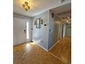 Inviting foyer featuring parquet flooring, a decorative light fixture, and an entryway into the home at 218 Omaha St S S St, Lake Hamilton, FL 33851