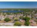 Aerial view of a cozy community with mature trees surrounding a beautiful lake at 23 Kendra Ct, Winter Haven, FL 33880