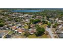 Aerial view showcasing the community, mature trees, and nearby lake at 23 Kendra Ct, Winter Haven, FL 33880