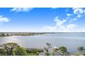 Expansive water view featuring a dock, lush greenery and a serene environment at 2750 W Lake Hamilton Dr, Winter Haven, FL 33881
