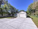 Beautifully renovated single-story home with a well-manicured lawn and new driveway at 3023 Thornhill Rd, Winter Haven, FL 33880