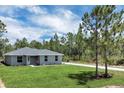 Charming single-story home with a well-manicured lawn and inviting entrance at 3120 Oleander Dr, Indian Lake Estates, FL 33855