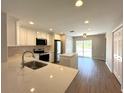 Modern kitchen featuring stainless steel appliances, an island, and sleek countertops at 3120 Oleander Dr, Indian Lake Estates, FL 33855