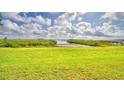 Spacious grassy backyard with water access and scenic views at 329 Hamilton Shores Ne Dr, Winter Haven, FL 33881