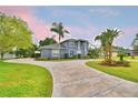 Charming two-story home with well-maintained landscaping and a spacious circular driveway at 329 Hamilton Shores Ne Dr, Winter Haven, FL 33881