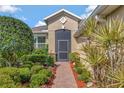 Home's entryway with brick walkway and decorative landscaping at 3710 Plymouth Dr, Winter Haven, FL 33884