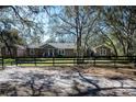 Inviting single-story home featuring a well-maintained lawn and classic wooden fencing at 4010 Paw Paw Trl, Lake Wales, FL 33898
