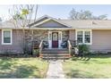 Inviting front porch with stone accents, charming decor, and a welcoming entrance at 4010 Paw Paw Trl, Lake Wales, FL 33898