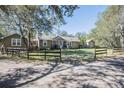 Charming one-story home with fenced yard surrounded by lush greenery and mature trees at 4010 Paw Paw Trl, Lake Wales, FL 33898