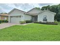 Charming single-story home featuring a brick driveway and a well-maintained front lawn at 4063 Birkdale Dr, Lake Wales, FL 33859