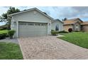 Charming home with a brick driveway, lush lawn, and well-maintained landscaping at 4063 Birkdale Dr, Lake Wales, FL 33859