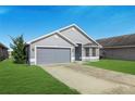Charming one-story home boasts a well-maintained lawn and a two car garage with a gray exterior paint at 4099 Island Lakes Dr, Winter Haven, FL 33881