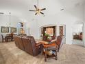 Bright living room with elegant furniture, tile flooring, and an open layout connecting to the dining area at 4313 Heath Land Ln, Lake Wales, FL 33859