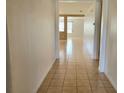Hallway featuring tile flooring and a view into the living area at 4610 Yellow Bay Dr, Kissimmee, FL 34758